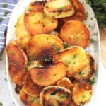 Crispy fried potatoes stacked on a serving plate