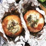 Two roasted onions wrapped in foil