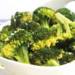 Close up of the sautéed broccoli in a white bowl.