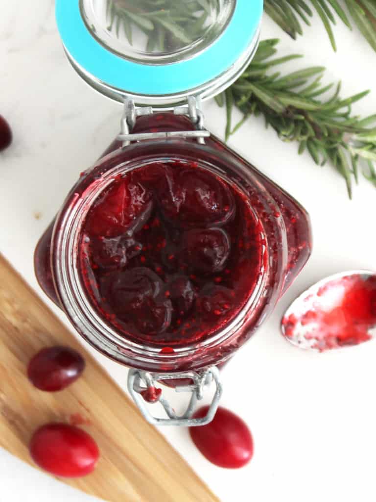 Overhead shot of the cranberry brown sugar sauce in a small mason jar.