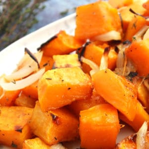 Close up of cubes of roasted butternut squash with onions.