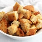 Garlic butter croutons in a white bowl.