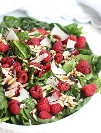 Shaved parmesan and raspberries on a bed of baby spinach and drizzled with balsamic.