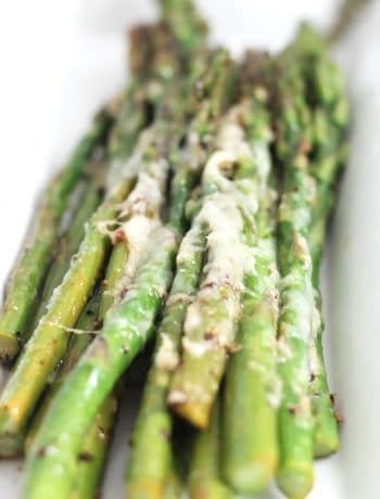 Close up of the melted cheese on the cooked asparagus spears.