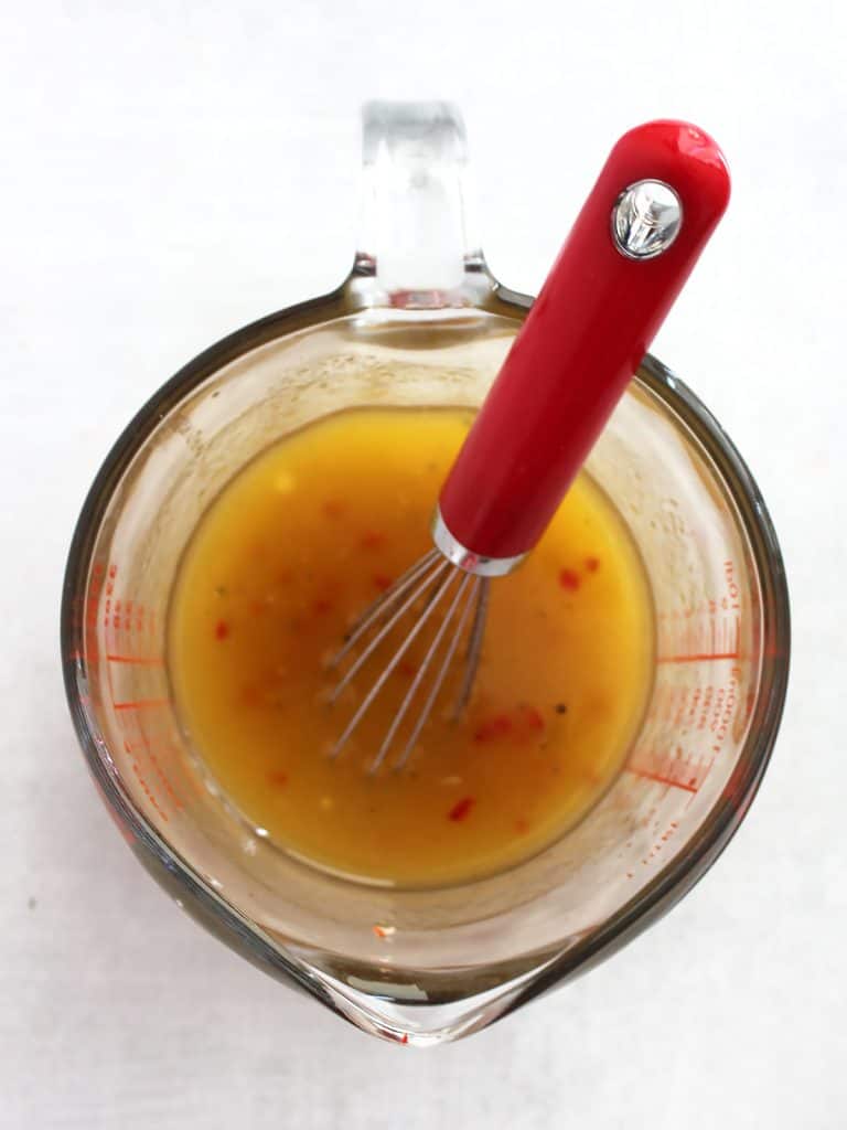 The dressing whisked together in a glass jug.