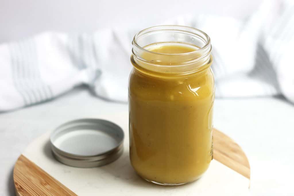 Maple mustard dressing in a small mason jar.