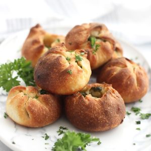 Pizza dough garlic balls garnished with fresh parsley.