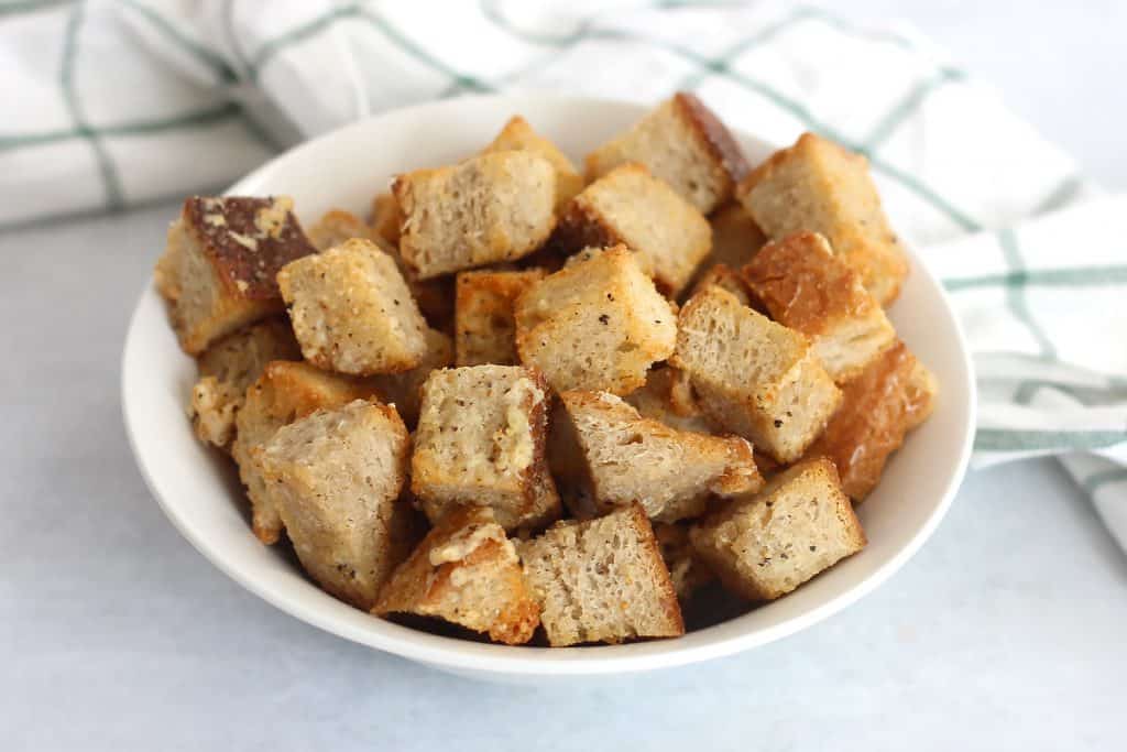 Air frued parmesan croutons in a bowl.