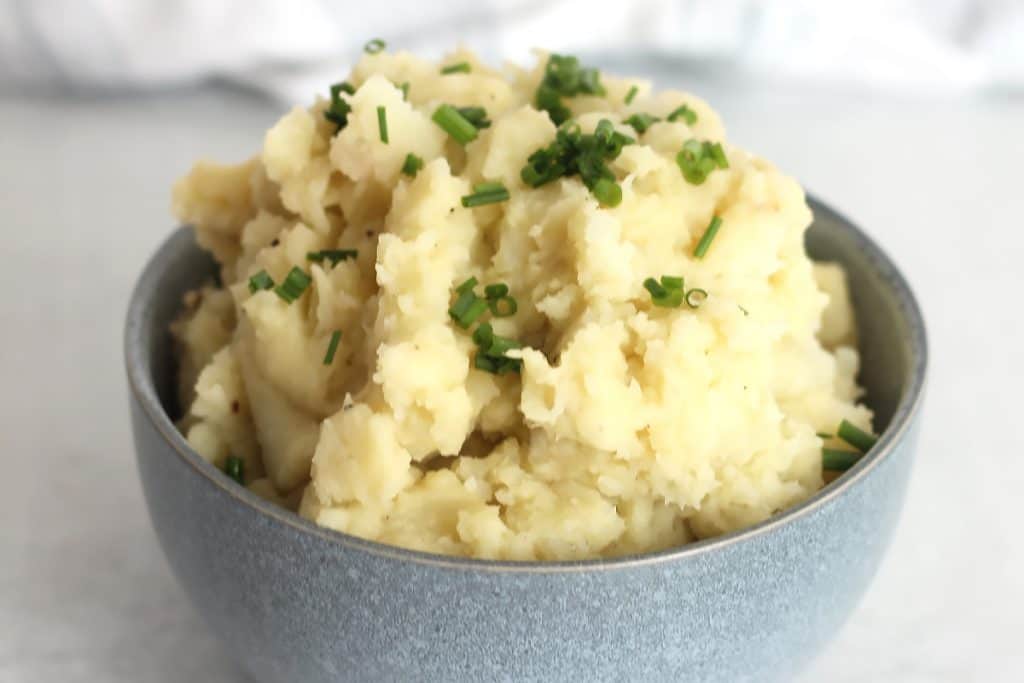 Almond milk mashed potatoes topped with chopped chives.