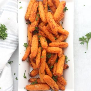 Close of up air fryer baby carrots garnished with fresh parsley.