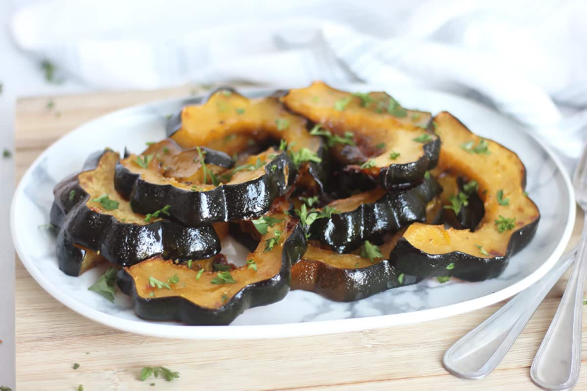 Maple roasted acorn squash on a serving plate.