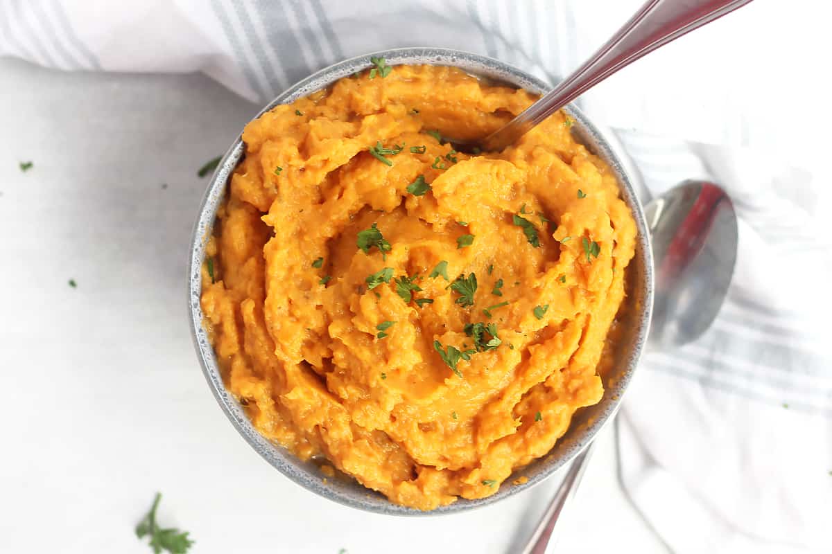Overhead shot of whipped sweet potatoes in a bowl with a spoon.