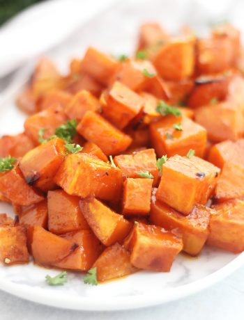 Roasted sweet potatoes garnished with fresh parsley.