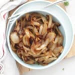 Air fried caramelized onions served in a small blue bowl.