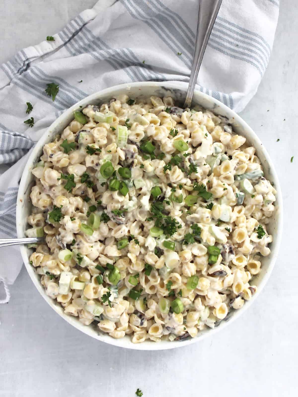 Overhead view of Creamy Bacon Blue Cheese Pasta Salad in a white serving bowl 