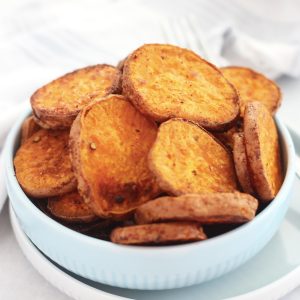 Baked sweet potato slices served in a blue bowl.