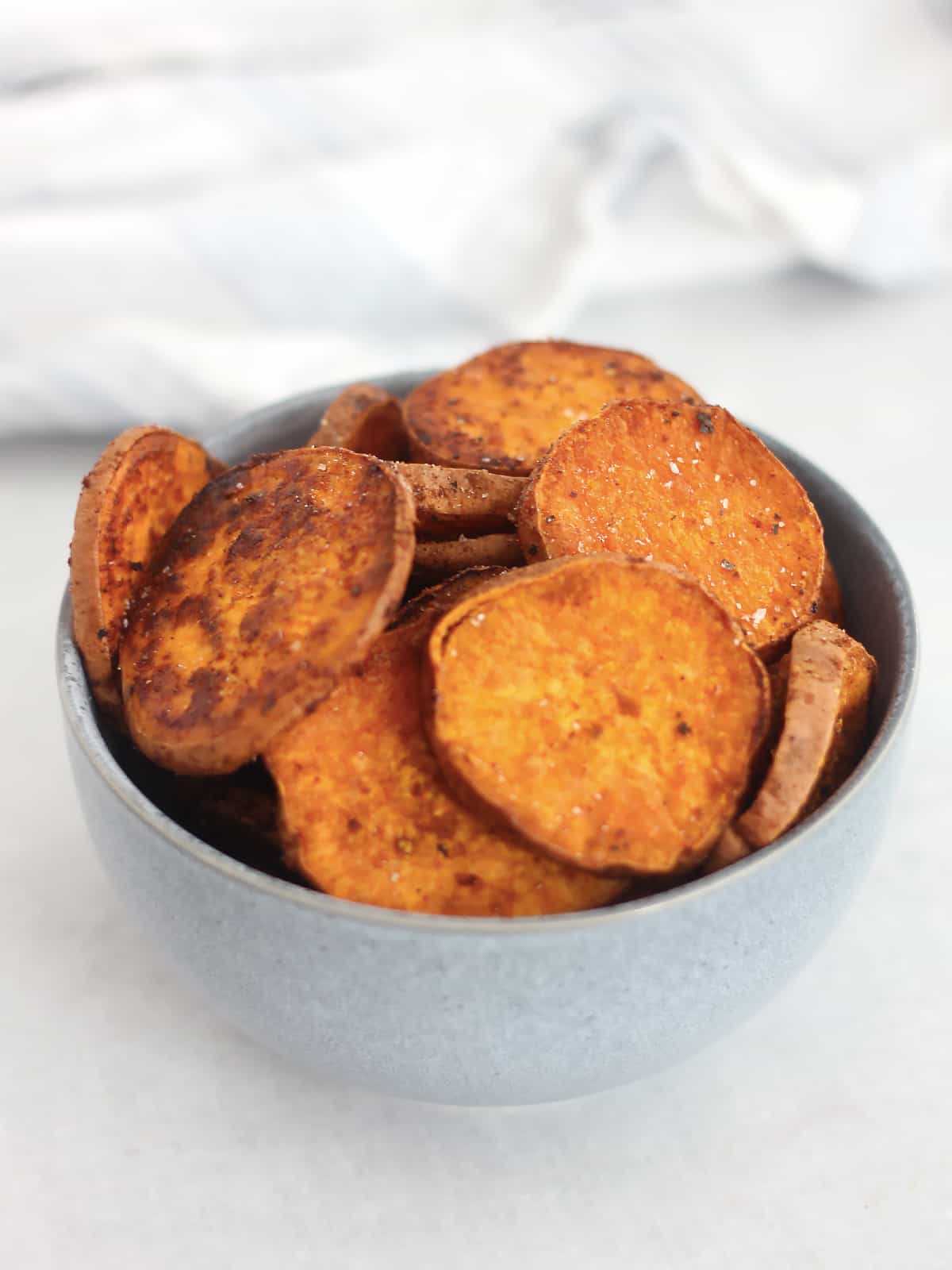 A bowl of baked sweet potato slices.