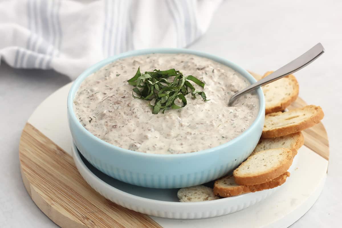Creamy garlic mushroom dip served with toasted baguette slices.