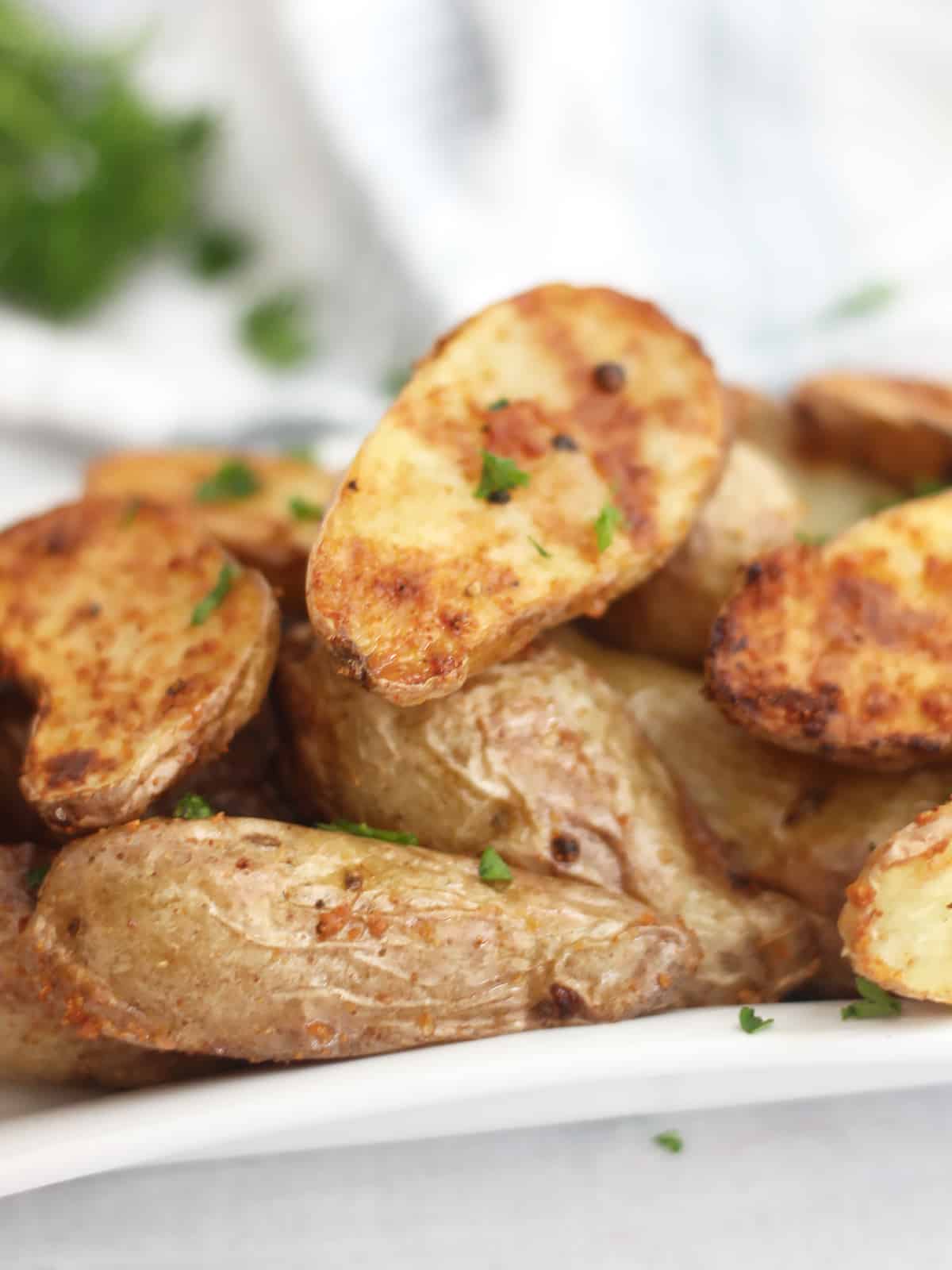 Parsley garnish on cooked potatoes.