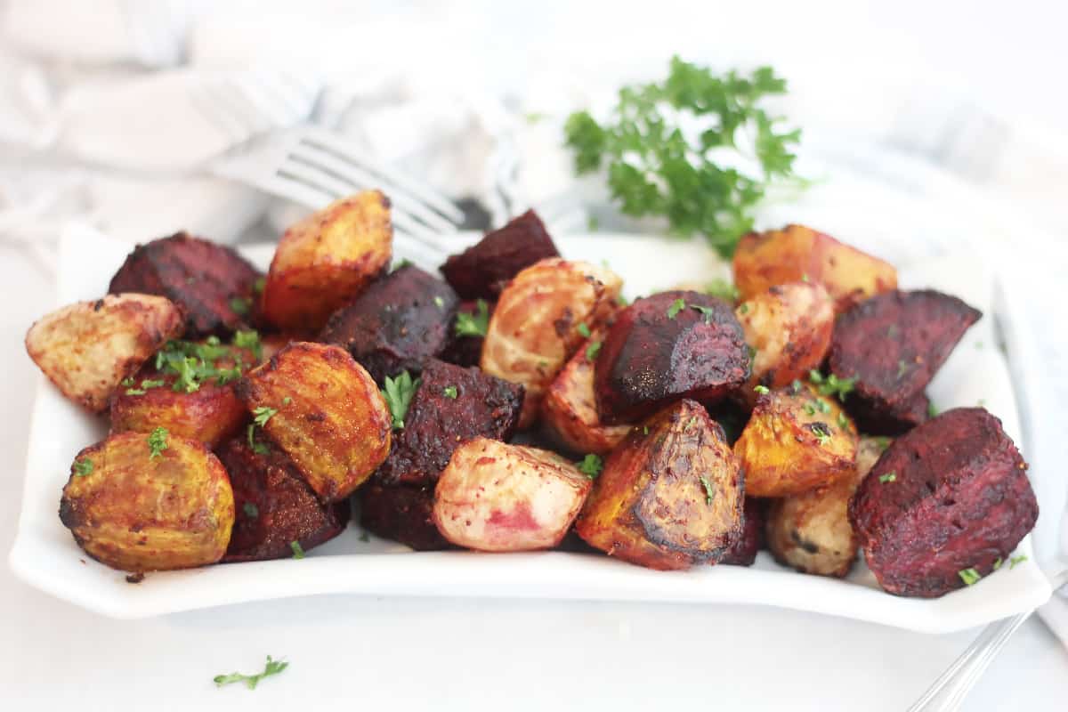 Air fryer roasted beets on a plate garnished with fresh parsley.