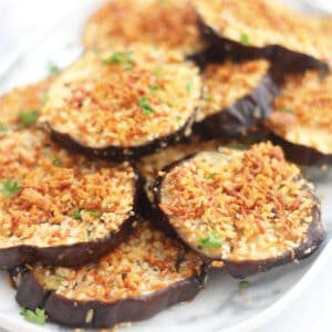 Close up of baked eggplant slices with panko breadcrumbs and parmesan.