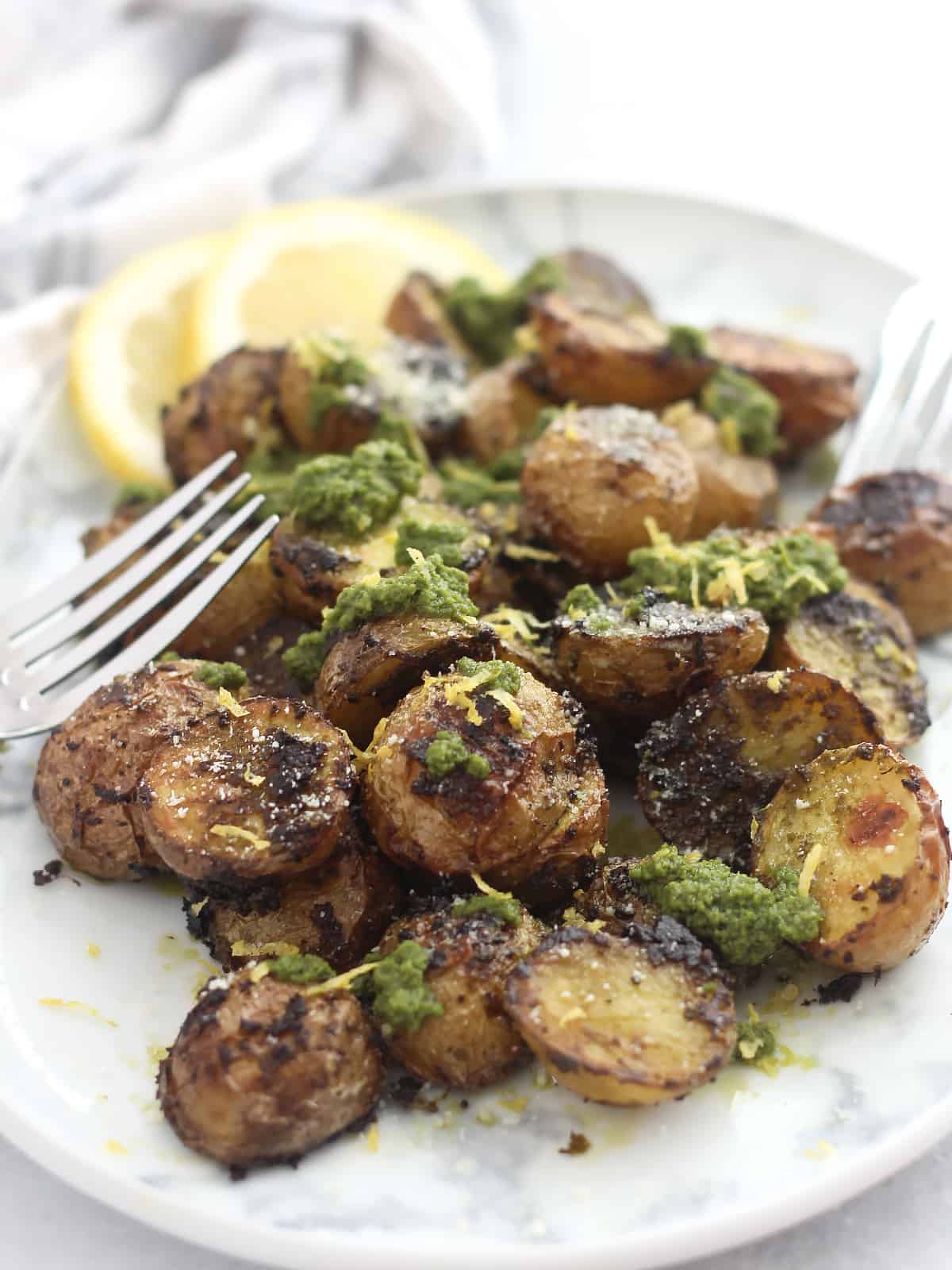 Halved roasted baby potatoes topped with fresh pesto.