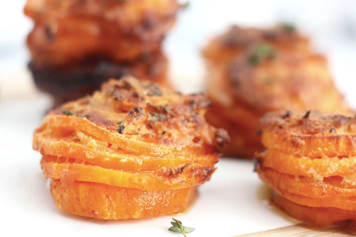 Four sweet potato stacks with cheese tops.