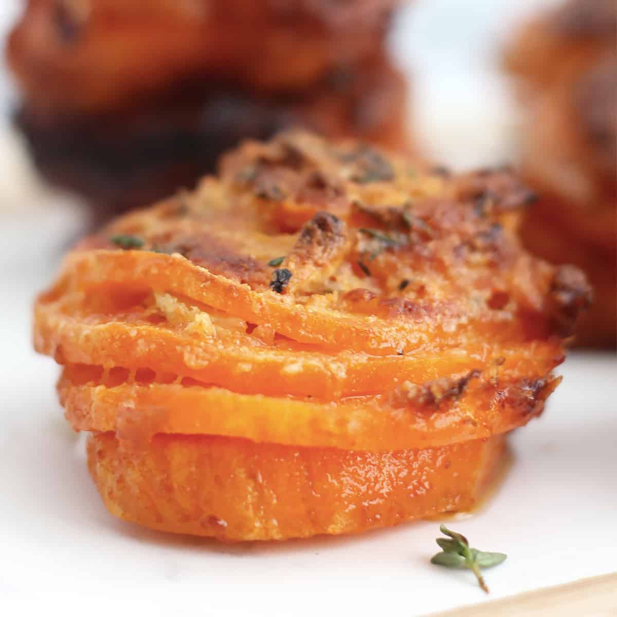 Close up of a sweet potato stack with parmesan.