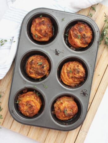 Overhead shot of baked sweet potato stacks in a muffin tin.