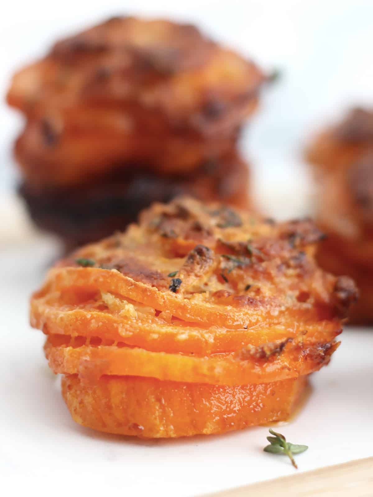 A baked sweet potato stack with four slices of sweet potato.