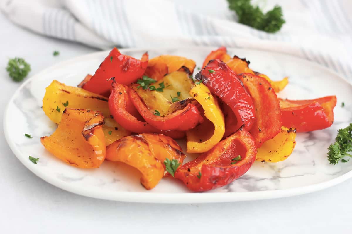 Air fried roasted bell peppers on a serving plate.