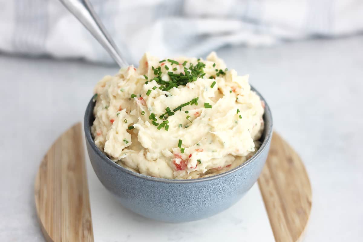 Whiped mashed potato salad in a bowl with a spoon.