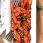 Roasted maple dijon carrots garnished with parsley.