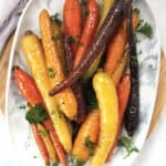 Rainbow carrots with a maple ginger glaze served on a plate.