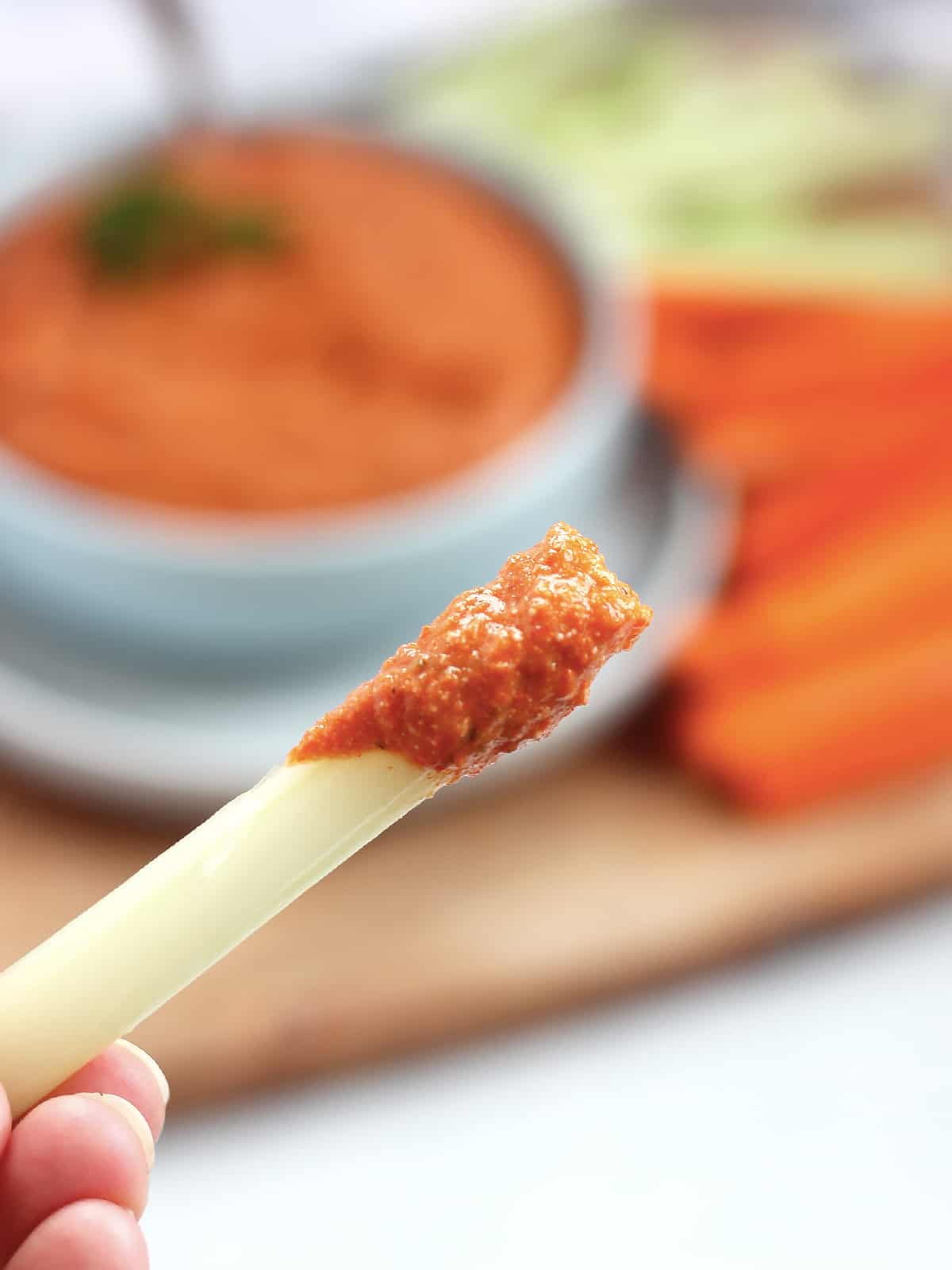Feta dip on a celery stick.