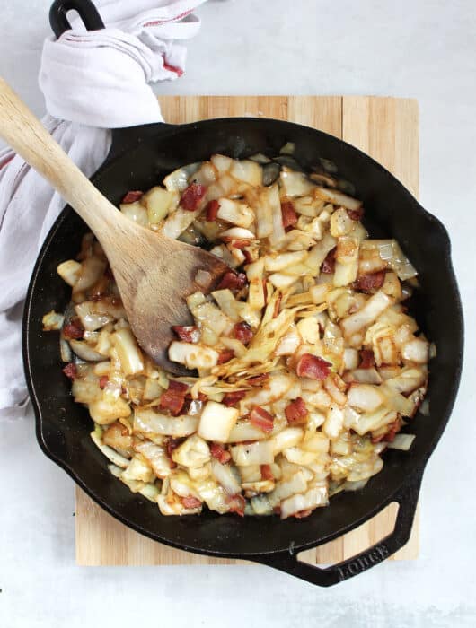 Sweet and sour German fried cabbage in a cast iron skillet.