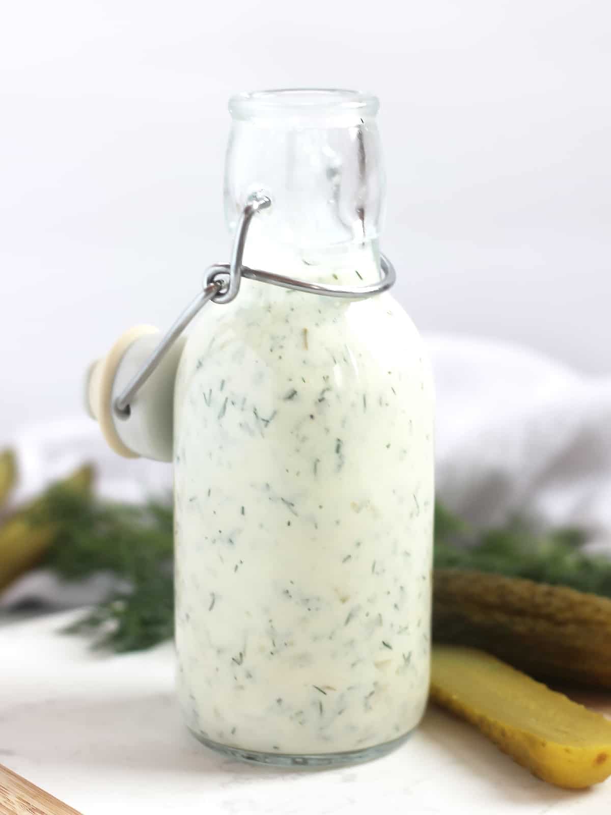 Dill pickle dressing in a glass bottle.