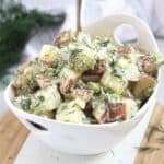 Creamy red skinned mashed potato salad with fresh dill and green onions.