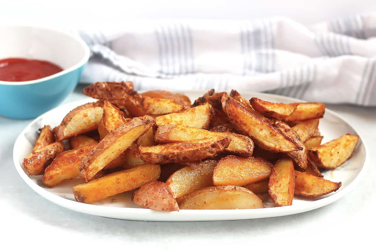 Red skin fries on a plate ready to eat.