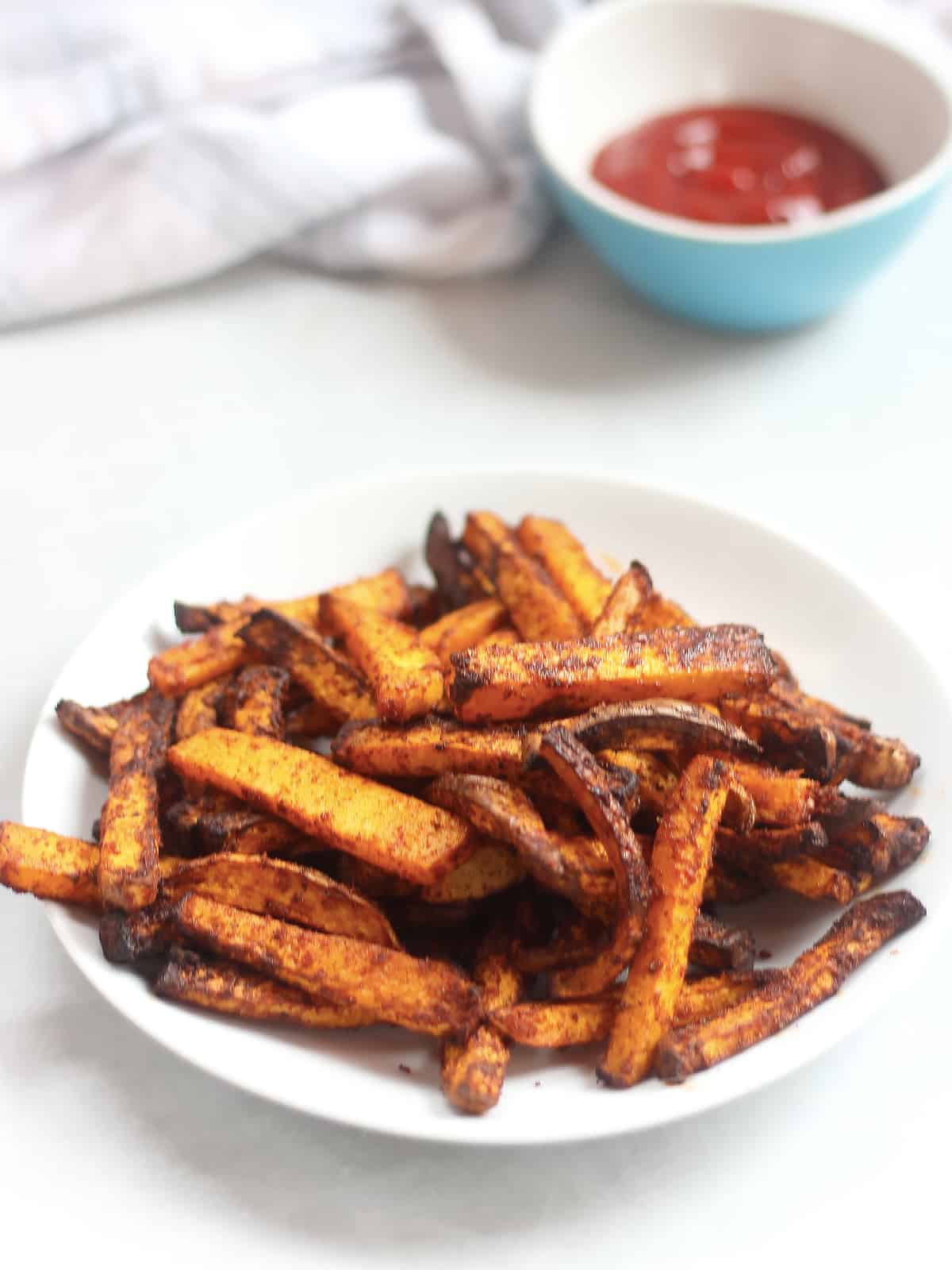 Vegetable fries with paprika on a white plate.