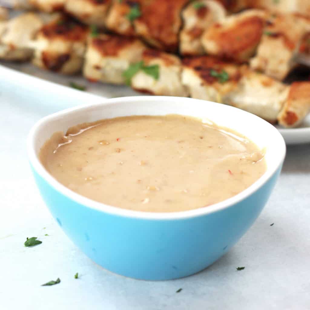 Thai peanut dipping sauce in a blue bowl.