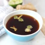 Honey soy dipping sauce in a small blue bowl.