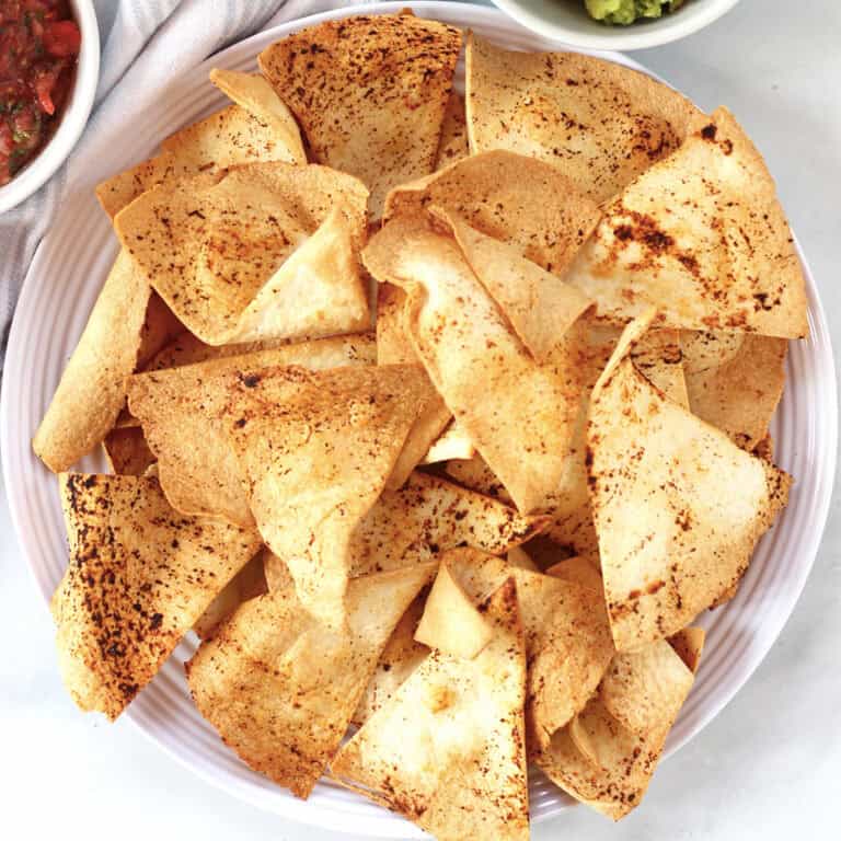 Tortillas served on a large white plate.