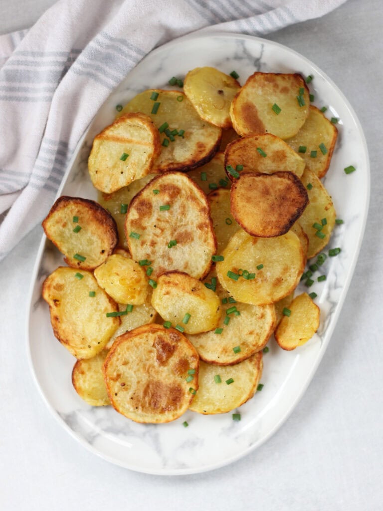 Golden brown sliced potatoes ready to eat.