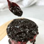 Savory blueberry sauce on a spoon.