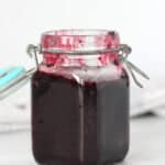 Red sauce in a glass storage jar.