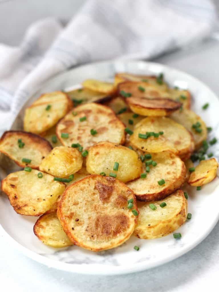 Crispy potato slices on a serving plate.