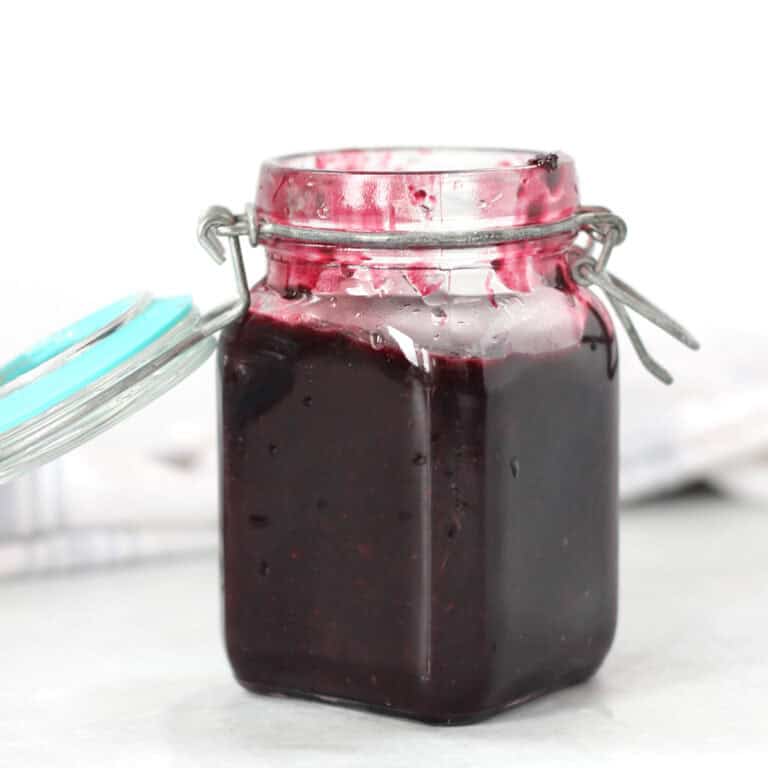 Savory blueberry sauce in a small storage jar.