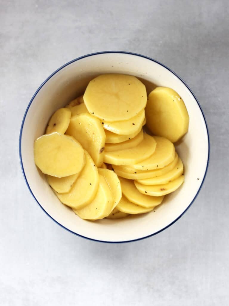 Sliced potatoes in a bowl.