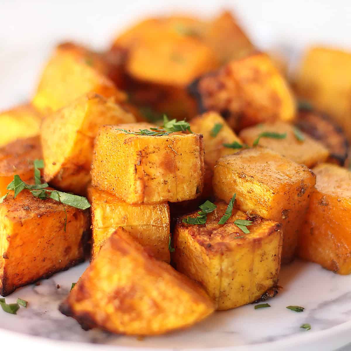 Air fried butternut squash cubes with caramelized edges.